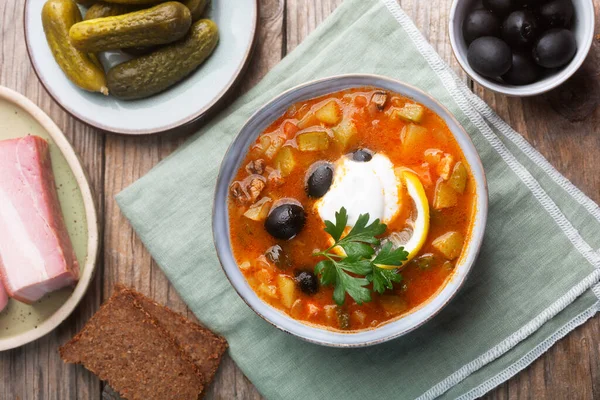 Solyanka, Russian soup with sausage, olives, pickled cucumber and capers. Top view — Stock Image Solyanka Russian Soup Sausage Olives Pickled Cucumber Capers Top View Stock Photo