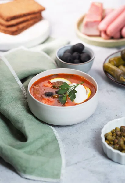 Solyanka, Russian soup with sausage, olives, pickled cucumber and capers — Stock Image Solyanka Russian Soup Sausage Olives Pickled Cucumber Capers Stock Picture