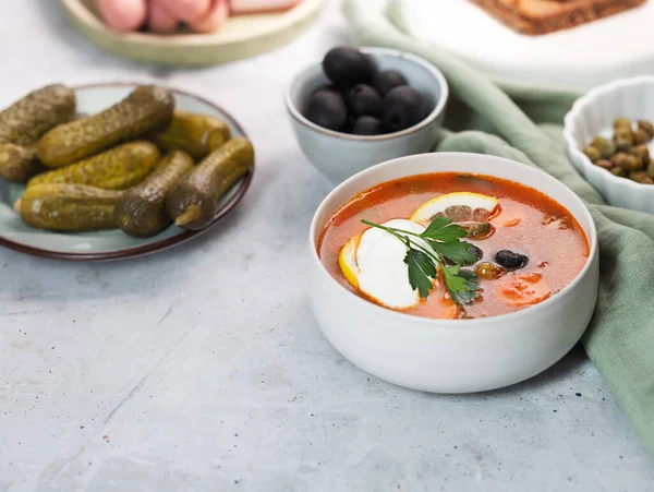 Solyanka, Russian soup with sausage, olives, pickled cucumber and capers — Stock Image Solyanka Russian Soup Sausage Olives Pickled Cucumber Capers Royalty Free Stock Images