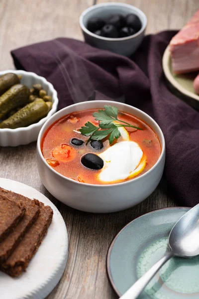 Solyanka, Russian soup with sausage, olives, pickled cucumber and capers — Stock Image Solyanka Russian Soup Sausage Olives Pickled Cucumber Capers Royalty Free Stock Images