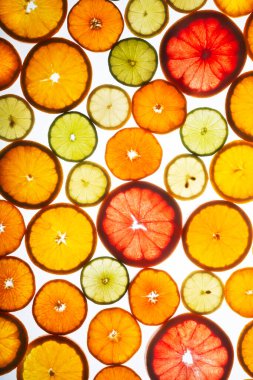 Abstract background of citrus slices on white
