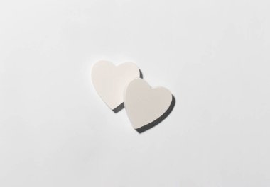 White hearts on the center of white paper background. Valentine's Day creative concept