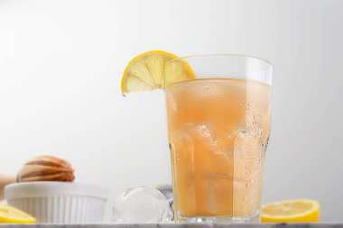 Kombucha cocktail with ice, prepared with fermenting tea with symbiotic culture of bacteria and yeast, image with copy space