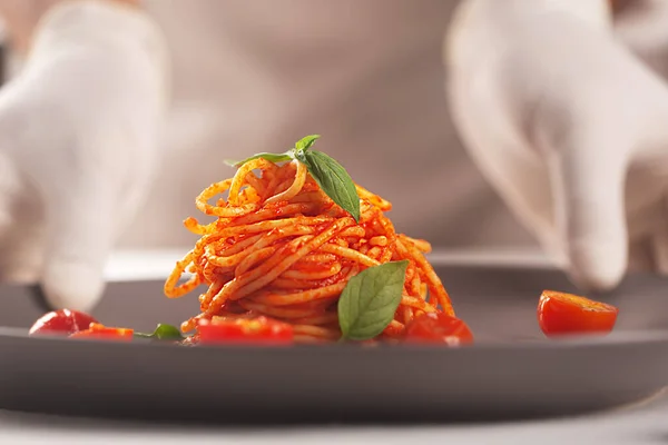 Chef Holds Plate Pasta Tomato Sauce His Gloved Hands Serving — Stock Photo, Image