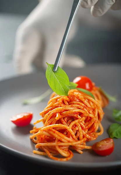 Chef Decorates Haute Cuisine Dish Gloves Tweezers Pasta Tomato Sauce — Stock Photo, Image
