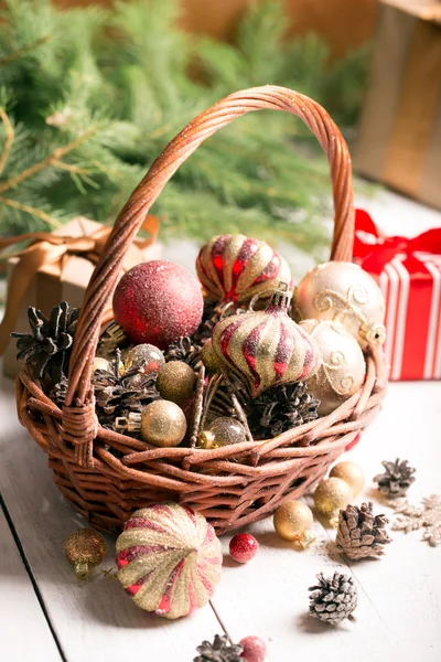 Christmas basket with red and golden ornaments — Stock Photo, Image
