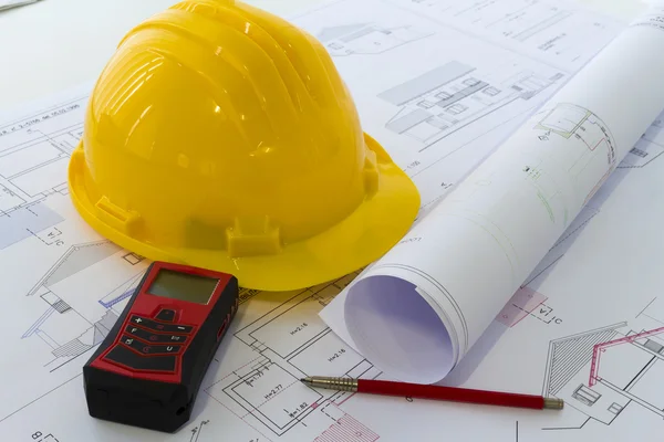 An office desk with the project papers and protective helmet — Stock Photo, Image