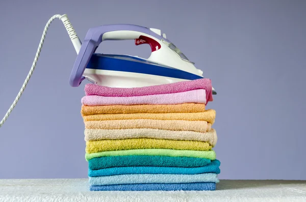 Ironing colorful towels — Stock Photo, Image