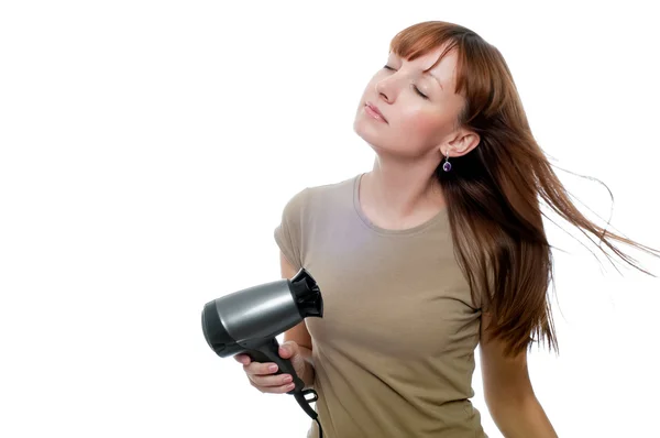 Redhead woman using hairdryer Royalty Free Stock Images