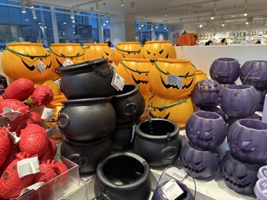 Varşova, Polonya - 28 Ekim 2025: Balkabağı kovaları, siyah kazanlar ve mor konteynerlerin yer aldığı canlı Cadılar Bayramı süslemeleri mevsimsel şenlikler için bir perakende alanında düzenlendi