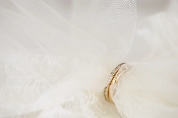 Wedding veil put through golden rings