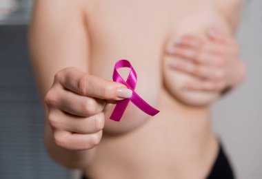 Göğüs kanseri farkındalığı kurdelesi. Siyah arka planda pembe kurdeleler. Yakın plan.