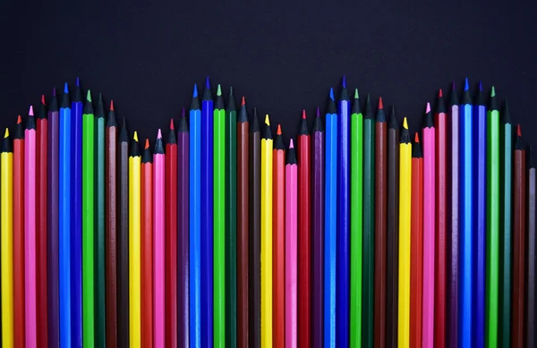 Set of Realistic Colorful Colored Pencils or crayons on a black background — Stock Photo, Image