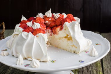 Sliced Pavlova Cake with Strawberries on White Plate clipart