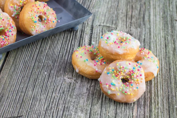 Beyaz şeker eski ahşap tahta üzerinde mini donuts sırlı