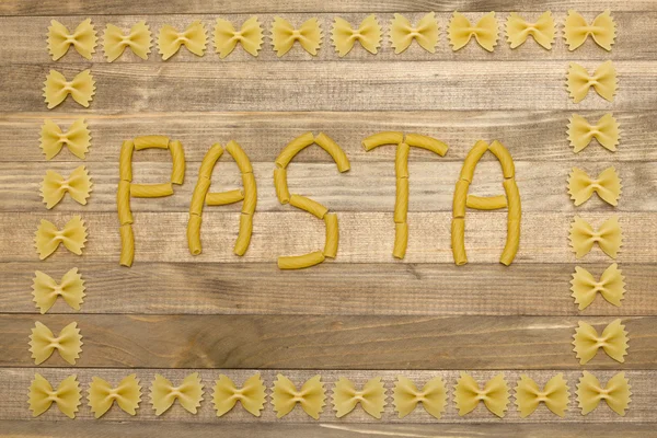 Texto de pasta hecha de pasta cruda — Foto de Stock