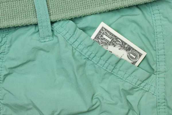 Un dólar en efectivo en el bolsillo de los pantalones —  Fotos de Stock