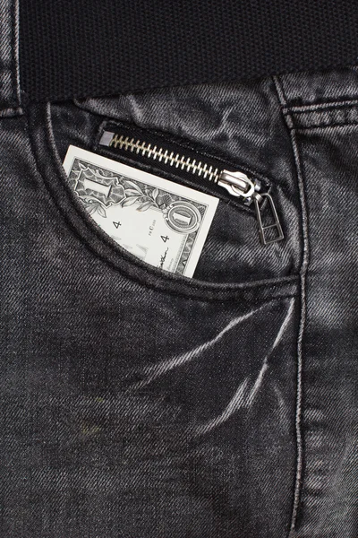 Один доллар наличными в кармане джинсов — стоковое фото