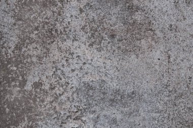 Gri bir duvarda desenli beton alçı