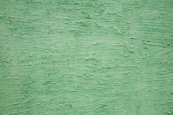 Getextureerd gips gemaakt op een groen gekleurde muur — Stockfoto