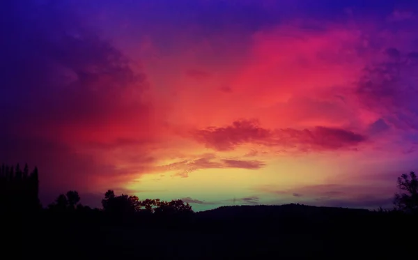 Purple sky sunset background wallpaper. Purple red orange yellow sky background with clouds sunset or sunrise.