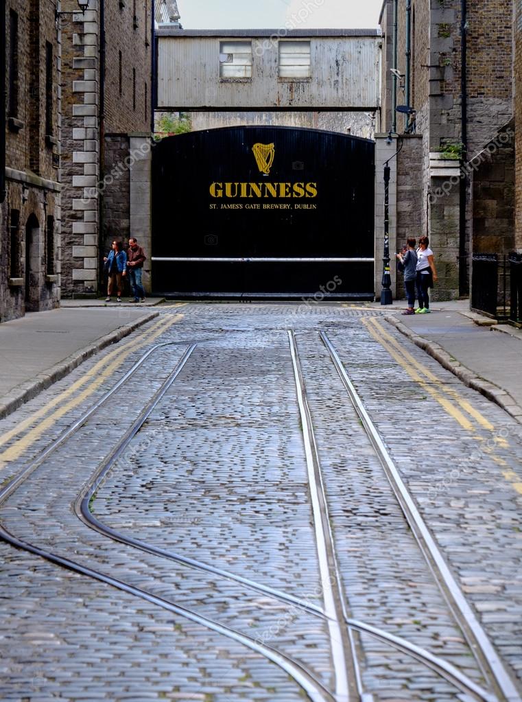 Dublin, Ireland. August 18, 2015. Famous gate with Guinness sign and logo and train tracks