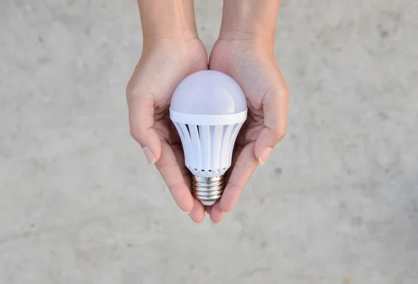 LED Bulb - saving technology in our hand — Stock Photo, Image