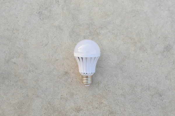 LED Bulb on the white concrete