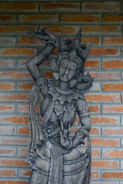 Thai style wood carving on the brick wall — Stock Photo, Image