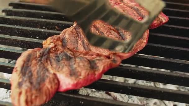 Cook touches beef steak on grill — Stock Video