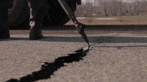 Sealing joint - crack in asphalt — Stock Video