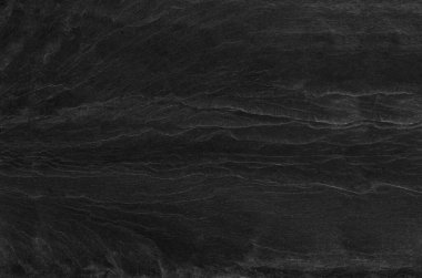 Siyah kaya arka planı. Koyu gri taş dokusu. Siyah grunge geçmişi. Dağ yakın çekim. Üzücü arkaplan.