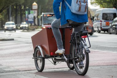 man with backpack on a cargo bike 
