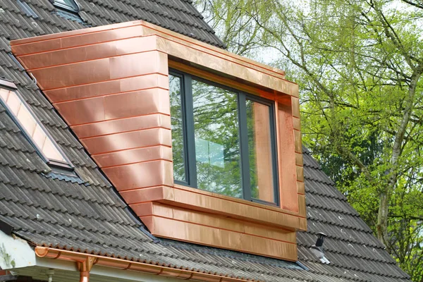 straight copper dormer with large window on rooftop