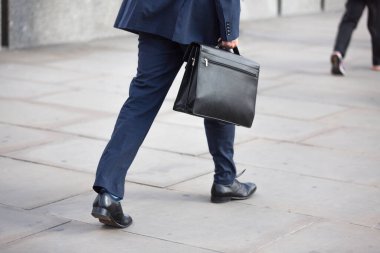 businessman with blue suit and black briefcase 
