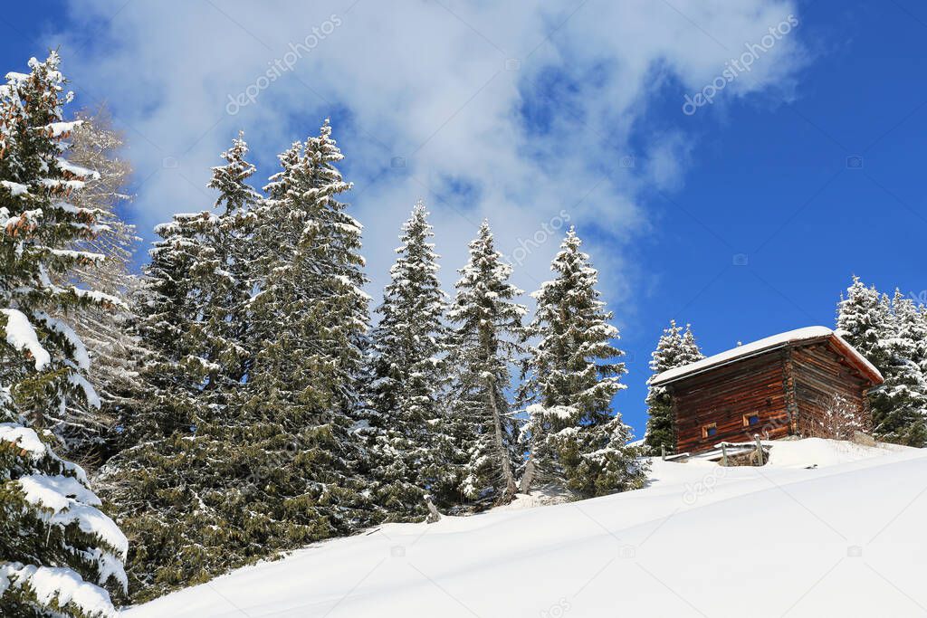 Wooden hut on a snowy slope