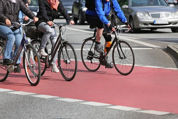 cyclists on red cycle lane