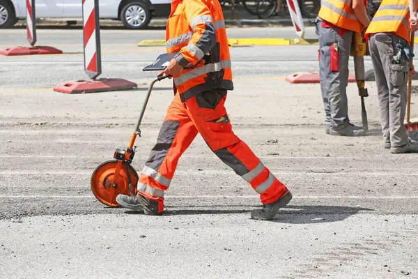 Worker Measuring Wheel Road Construction Site Stock Photo