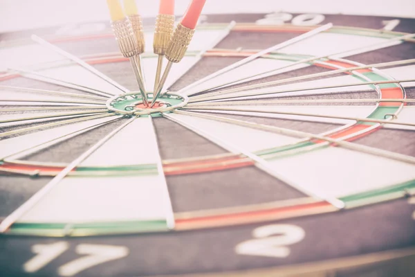 target dart with target arrows on the bokeh background and dartboard is the target and goalabstract background to target marketing or target arrow or target business concept .