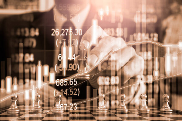 Chess game on chess board behind business man background. Business concept to present financial information and marketing strategy analysis. Investment target in global economy and digital commercial.