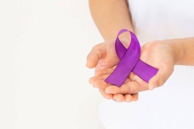 Elleri mor ya da mor kurdeleli beyaz kumaşlı ve kopyalanmış. Pankreas kanseri, Testis kanseri farkındalığı, kanserden kurtulma, leyomiyosarkom, Dünya Kanser Günü. Sağlık sigortası, sigorta kavramı.