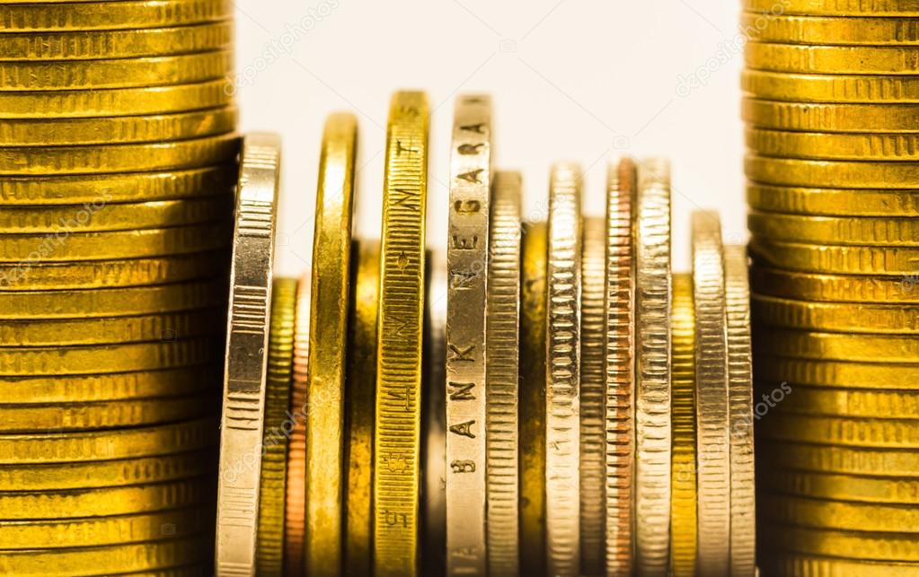 golden coins and coins stacked on each other in different positi
