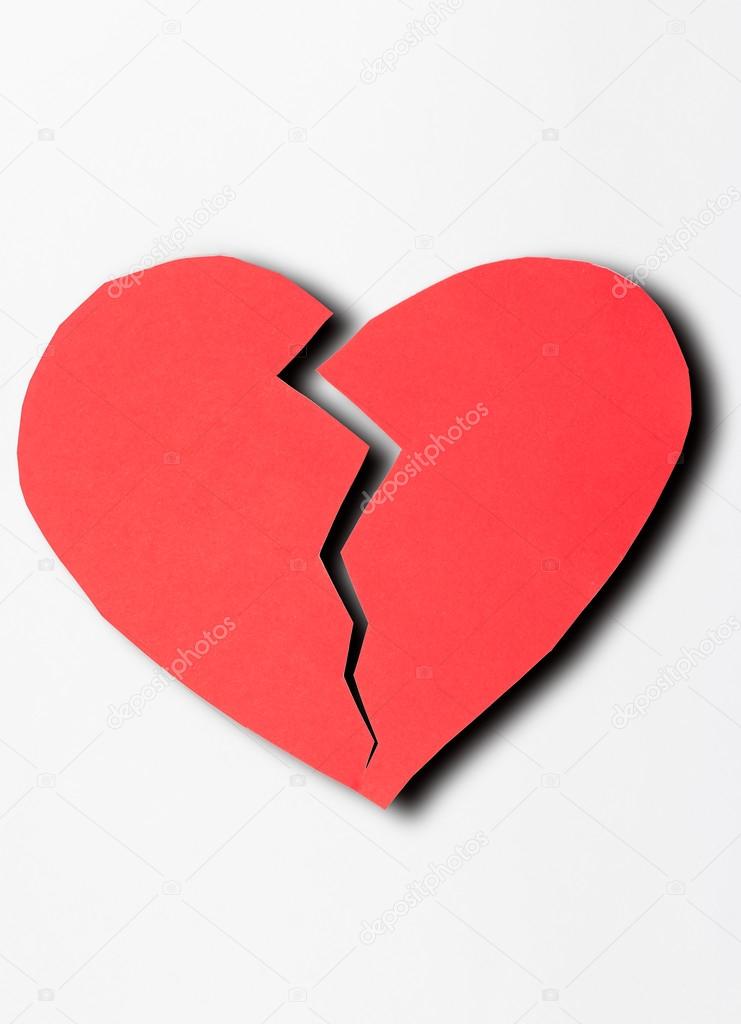 close up of paper broken heart on white background