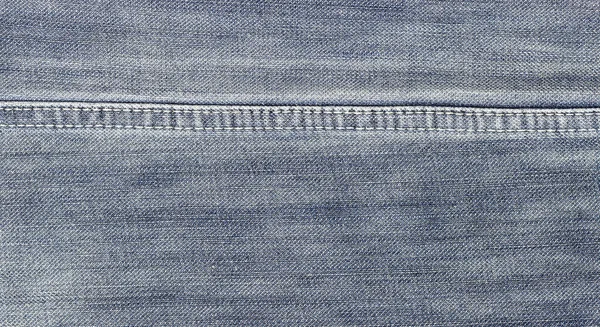 Närbild av denim jeans textur med sömmar — Stockfoto