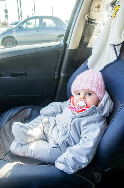 Newborn car sitting front seat dressed winter — Stock Photo, Image
