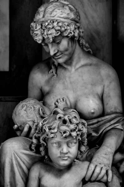 Статуя кормящей женщины детей в художественной черно-белой рамке — стоковое фото