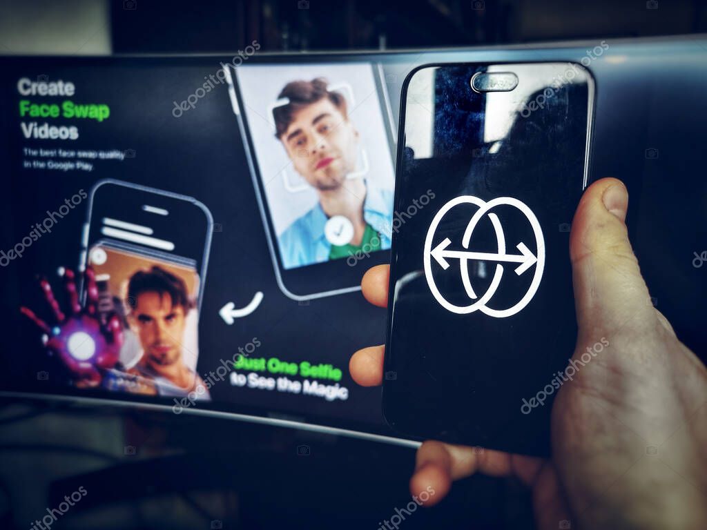 Hand use face swap app icon of Reface App on smartphone in Bologna, Italy, 10 Feb 2021