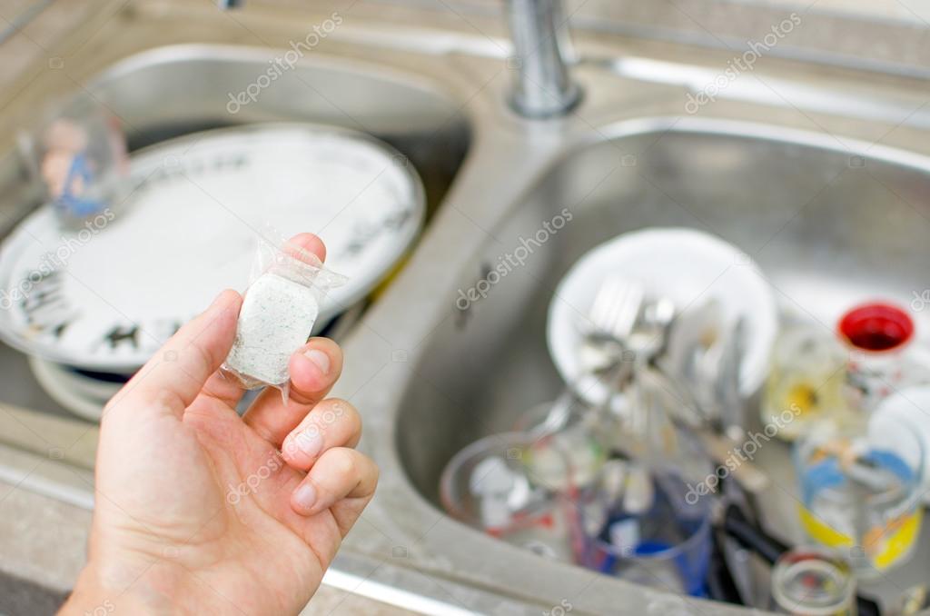 chores, dishwasher tab to wash dirty dishes on the sink