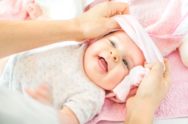 Dressing newborn baby pink — Stock Photo, Image