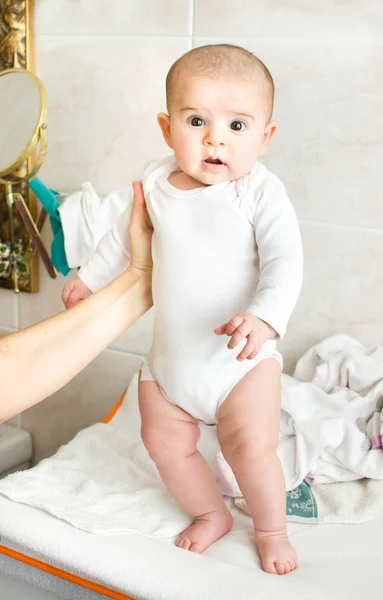 Newborn baby held up stand up thighs — Stock Photo, Image
